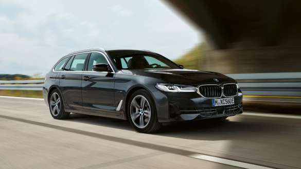 Plug-in хибрид BMW Серия 5 Туринг 2021 G31 три четвърти изглед отпред в движение Plug-in хибрид BMW Серия 5 Туринг 2021 G31 три четвърти изглед отпред в движение на пътя