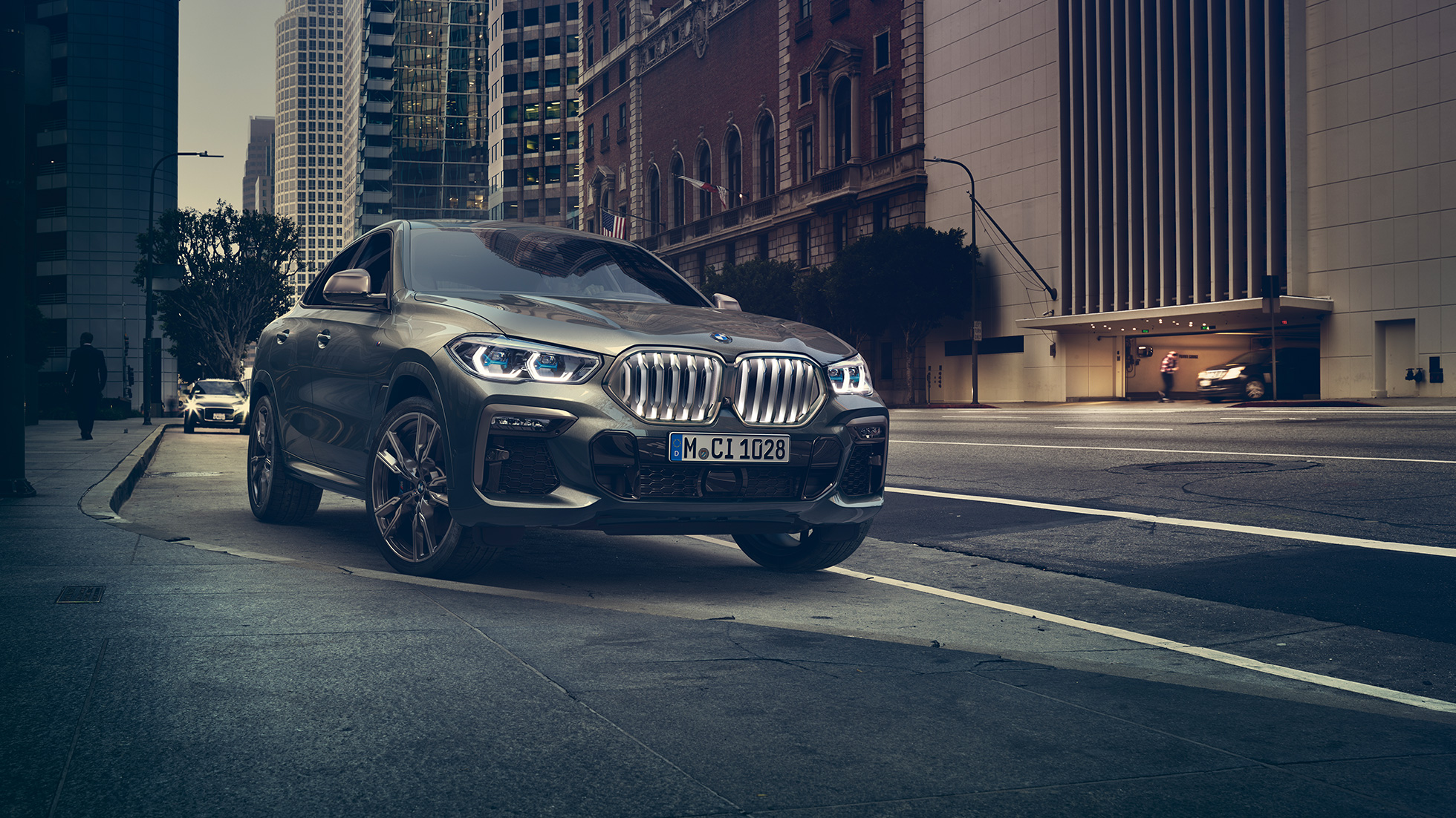 BMW X6 M50i в покой BMW X6 M50i, три четвърти изглед отпред, в покой на фона на града